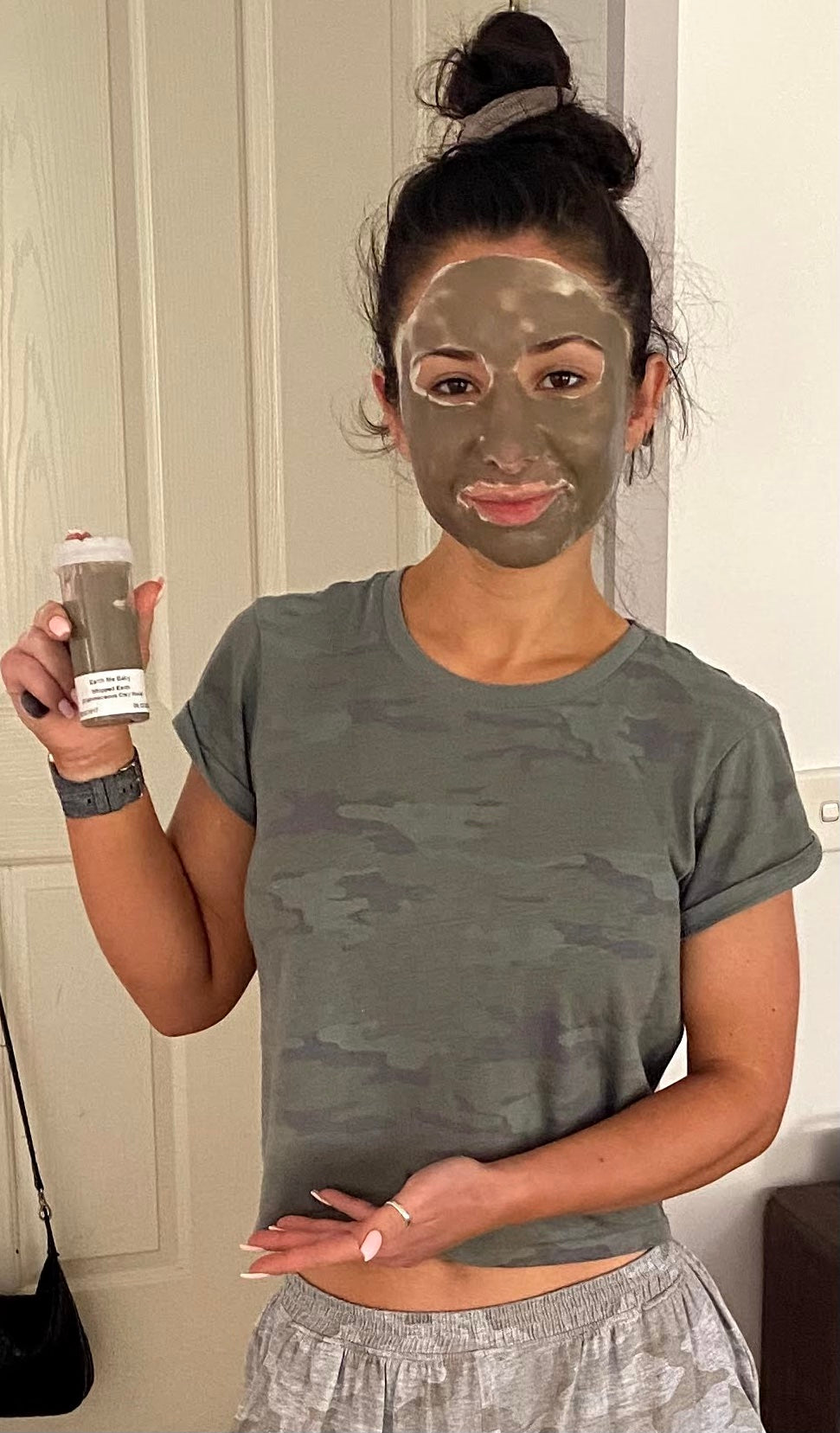 Ece with face covered in whippedearth, holding a container of the first whippedearth tube
